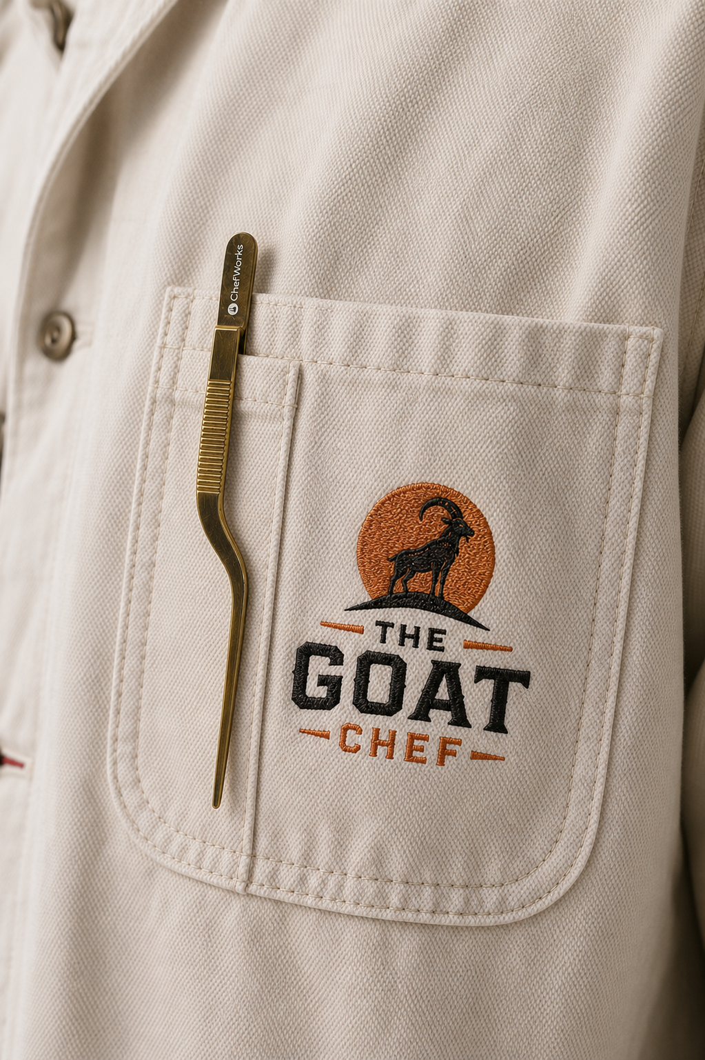 Close-up of GOAT Chef embroidery on Oatmeal Executive Chore Coat